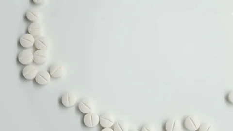 White pills rotating, from the left side on white background Stock Footage 83692448
