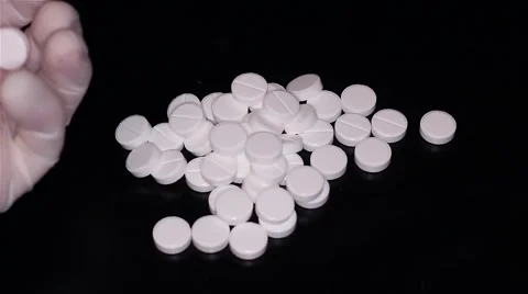 White pills scattered on the table Stock Footage 55821940