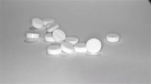 White pills scattered on the table Stock Footage 55821961
