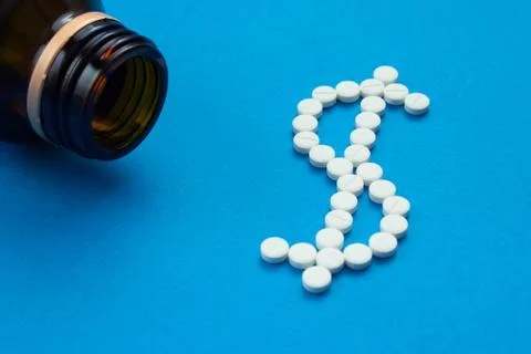 White pills in the shape of a dollar Stock Photos