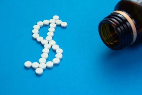 White pills in the shape of a dollar Stock Photos