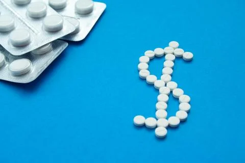 White pills in the shape of a dollar Stock Photos