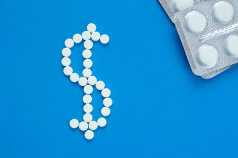 White pills in the shape of a dollar Stock Photos