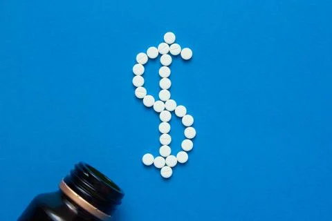 White pills in the shape of a dollar Stock Photos