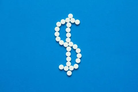White pills in the shape of a dollar Stock Photos