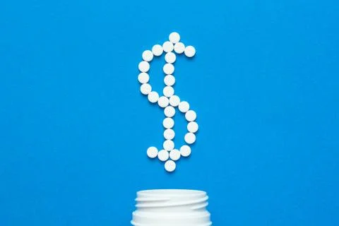 White pills in the shape of a dollar Stock Photos