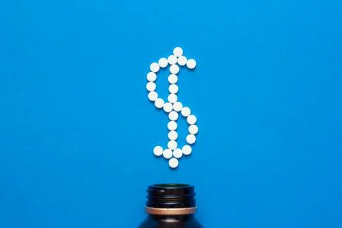 White pills in the shape of a dollar Stock Photos