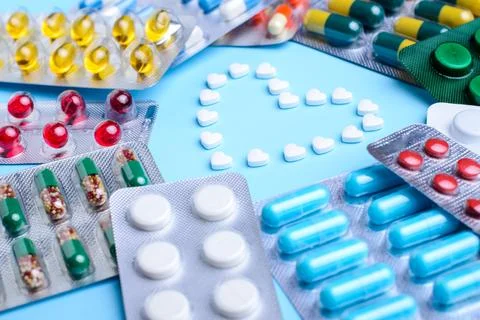 White pills in the shape of heart Stock Photos