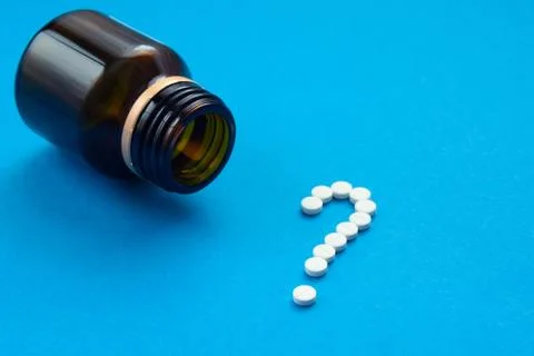 White pills in the shape of a question mark Stock Photos
