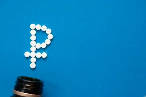 White pills in the shape of a ruble Stock Photos