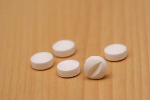 White pills on the table. Selective focus. Stock Photos