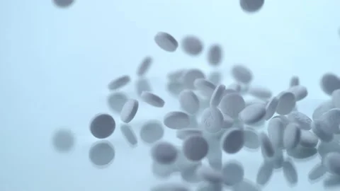 White pills tablets falling down on bright pure surface 库存影片 169245912