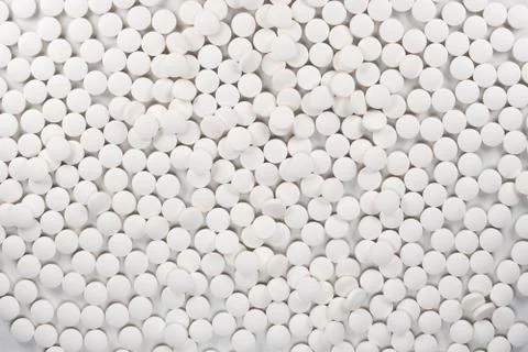 White pills, tablets on white background. Stock Photos