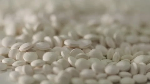 White pills on a turntable Stock Footage 249973820