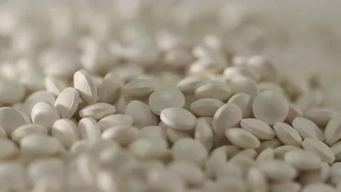 White pills on a turntable Stock Footage 249973838