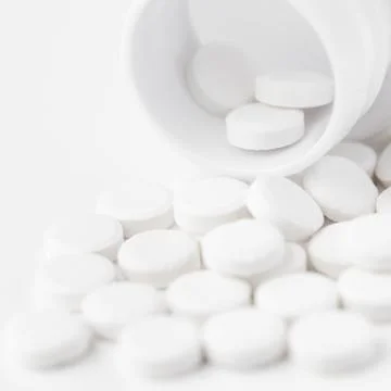 White pills on white background Stock Photos