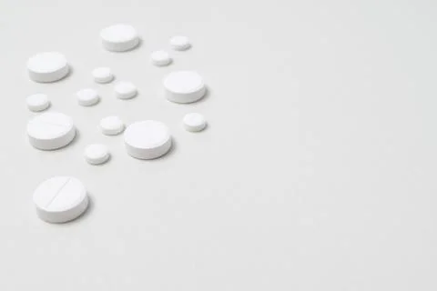 White pills on a white background Stock Photos