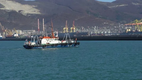 White pilot tug is sailing along Novorossiysk Bay towards pier on  western pier Stock Footage 165387171