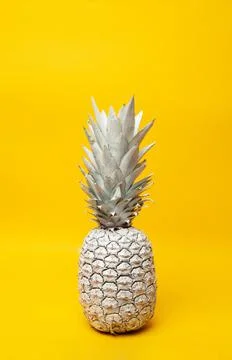 White pineapple on table in studio on yellow background Stock Photos
