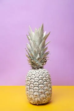 White pineapple on yellow table in studio Stock Photos