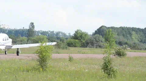 White plane goes down the runway Stock Footage 24497679