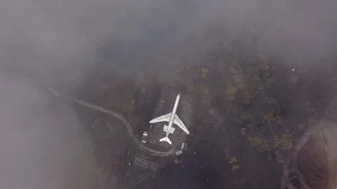 A white plane stands on a closed platform in the forest Stock Footage 144349548