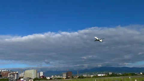 White plane taking off wide shot above Batumi coastline Stock Footage 345361886