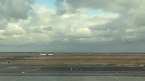White plane is traveling down road. View of airport runway Stock Footage 287779596