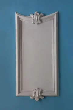 White plaster decor on a blue wall Stock Photos
