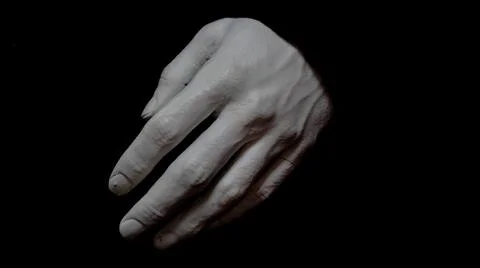 White plaster hand on black background Stock Photos