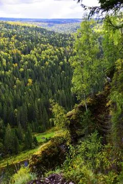 White, plaster, moss-covered sheer cliffs of Usvinskie Stolby (Perm Territory Stock Photos