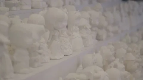 White plaster statues made by children in the children's entertainment area of t Stock Footage 157853600
