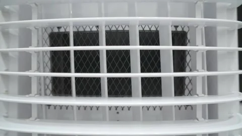 White plastic air conditioner or cooler vent with protective black mesh grille. Stockbeeldmateriaal 334733850