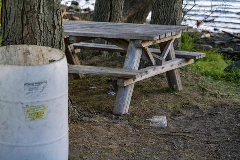 White plastic barrel for garbage in a park near Rockland Lake, New York. Stock Photos