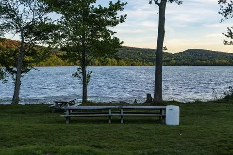 White plastic barrel for garbage in a park near Rockland Lake, New York. Stock Photos