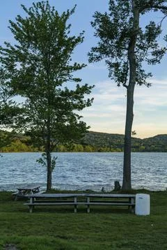 White plastic barrel for garbage in a park near Rockland Lake, New York. Stock Photos
