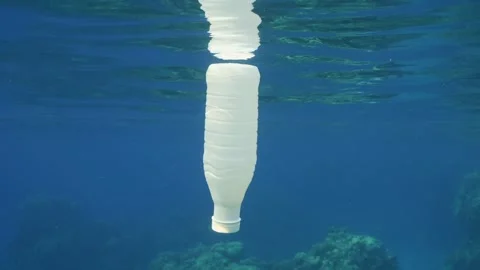 White plastic bottle drifts under surface of blue ocean, Slow motion Stock Footage 246358133
