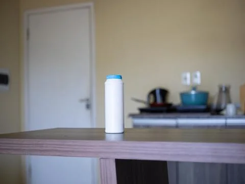White plastic bottle on kitchen table indoors Stock Photos
