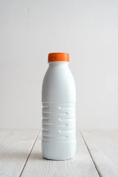 White plastic bottle on a light background. Side view with copy space. Stock Photos