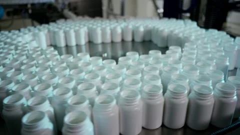White Plastic Bottles On Rotating Accumulation Table, Factory Hall, Wide Shot Stock Footage 341331072