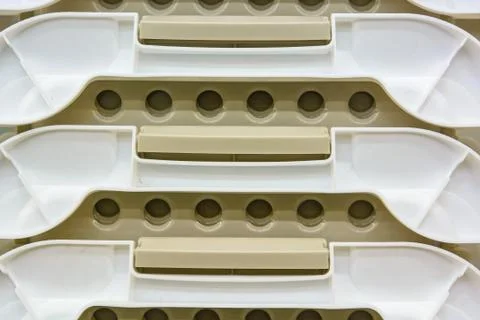 White plastic boxes stacked one upon the other Stock Photos