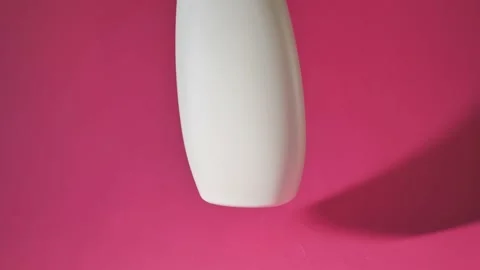 White plastic can rotates on a pink background Stock Footage 227029201