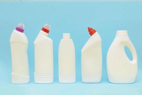White plastic container on blue background. Powder bottle mockup Stock Photos