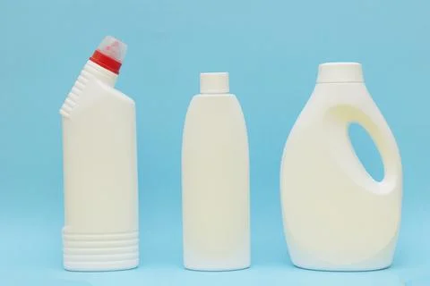 White plastic container on blue background. Powder bottle mockup Stock Photos