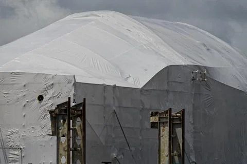 White plastic covers a large building while major repairs are carried out t.. Stock Photos