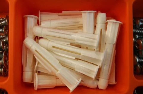 White plastic dowels in a box. Close-up Stock Photos