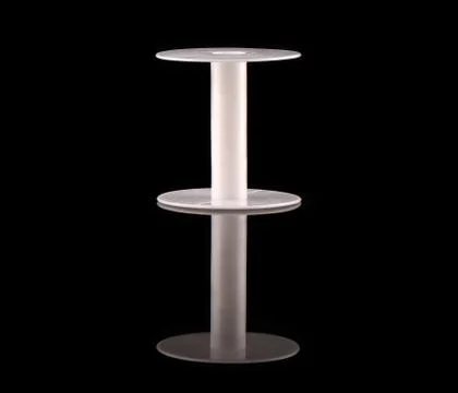 White plastic empty coil on a black background with reflection. Stock Photos