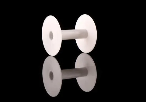 White plastic empty reel on a black background with reflection Stock Photos