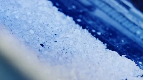 White Plastic Flakes Heaped in Blue Light, Macro Powder Texture, Diagonal View Stock Footage 341301488