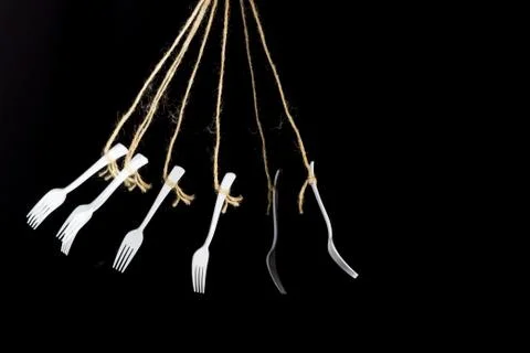 White plastic fork on black background Stock Photos